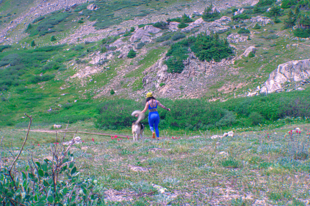 Kate Davie and Mighty Moose run through the Colorado hills.