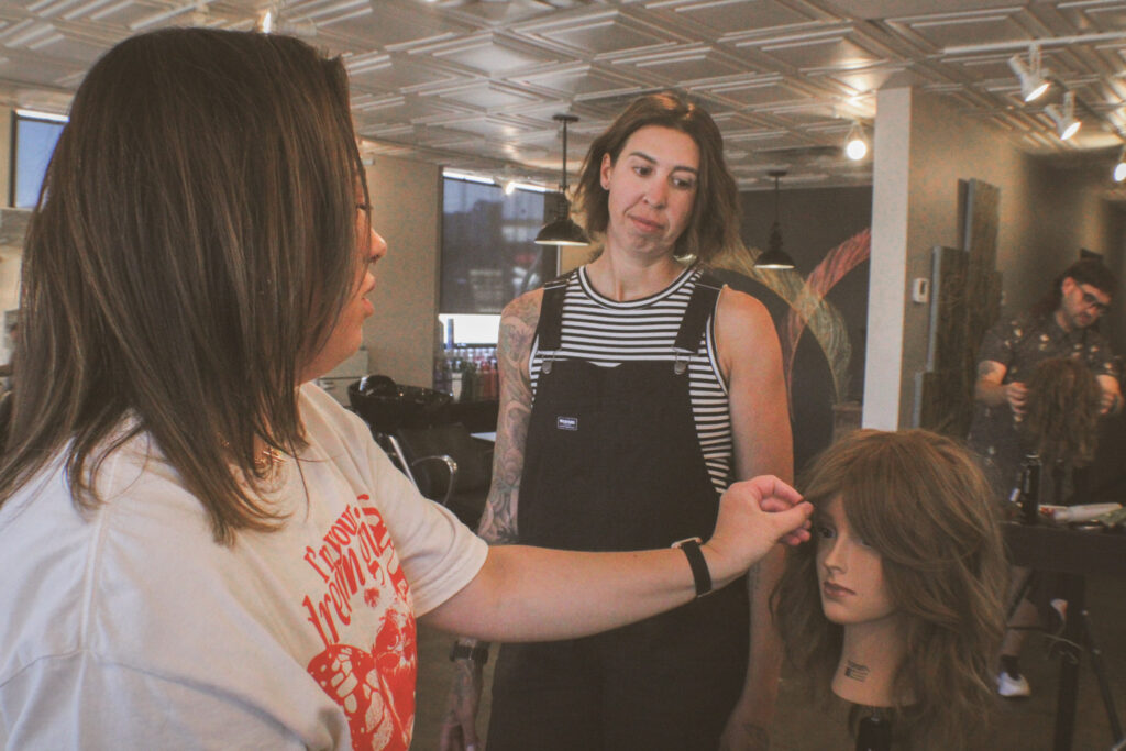 Hallie supervises Megan during the styling process.