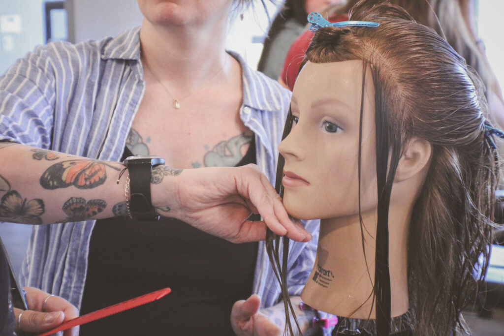 Amber guides Emma through the details of cutting petals into the fringe.