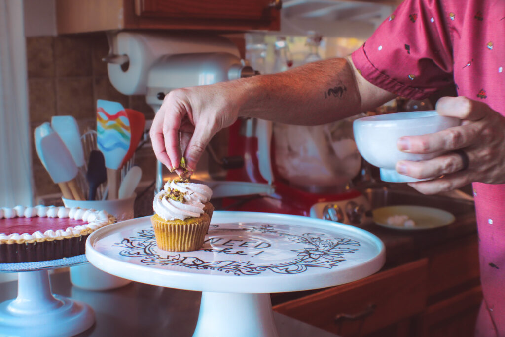 Scott sprinkles his elaborate cupcakes with pistachio toppings.