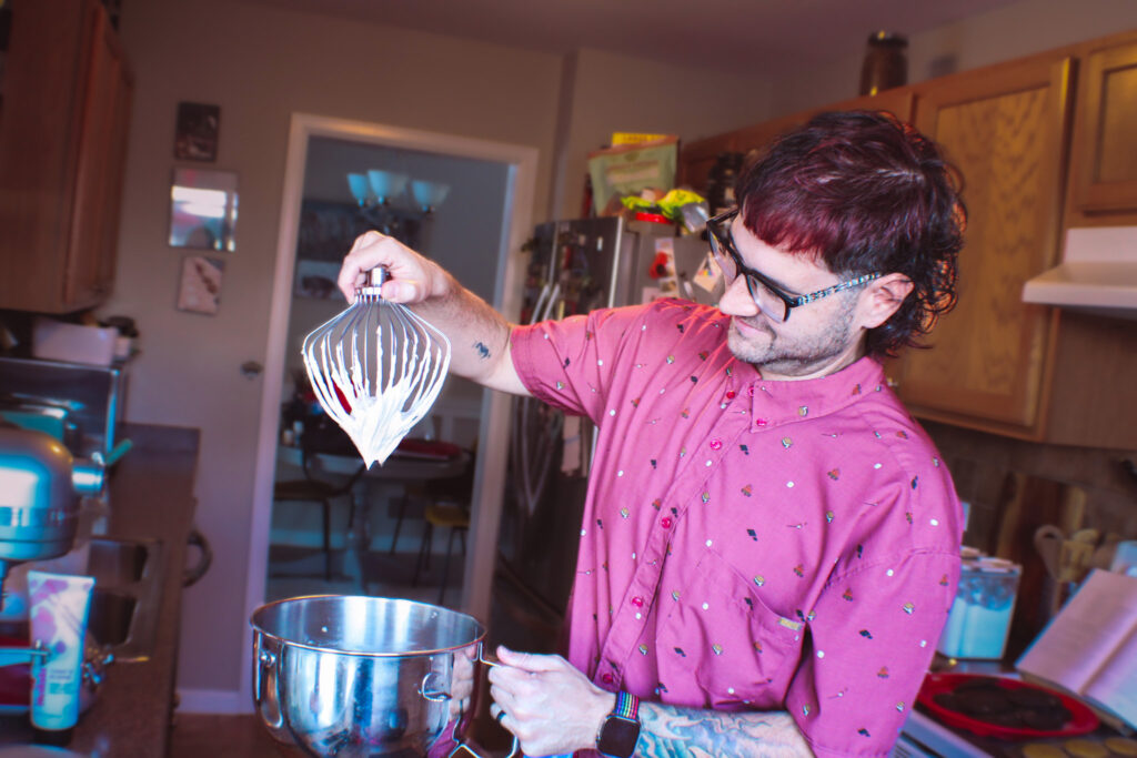 He knows how to check for the perfect whipped filling.